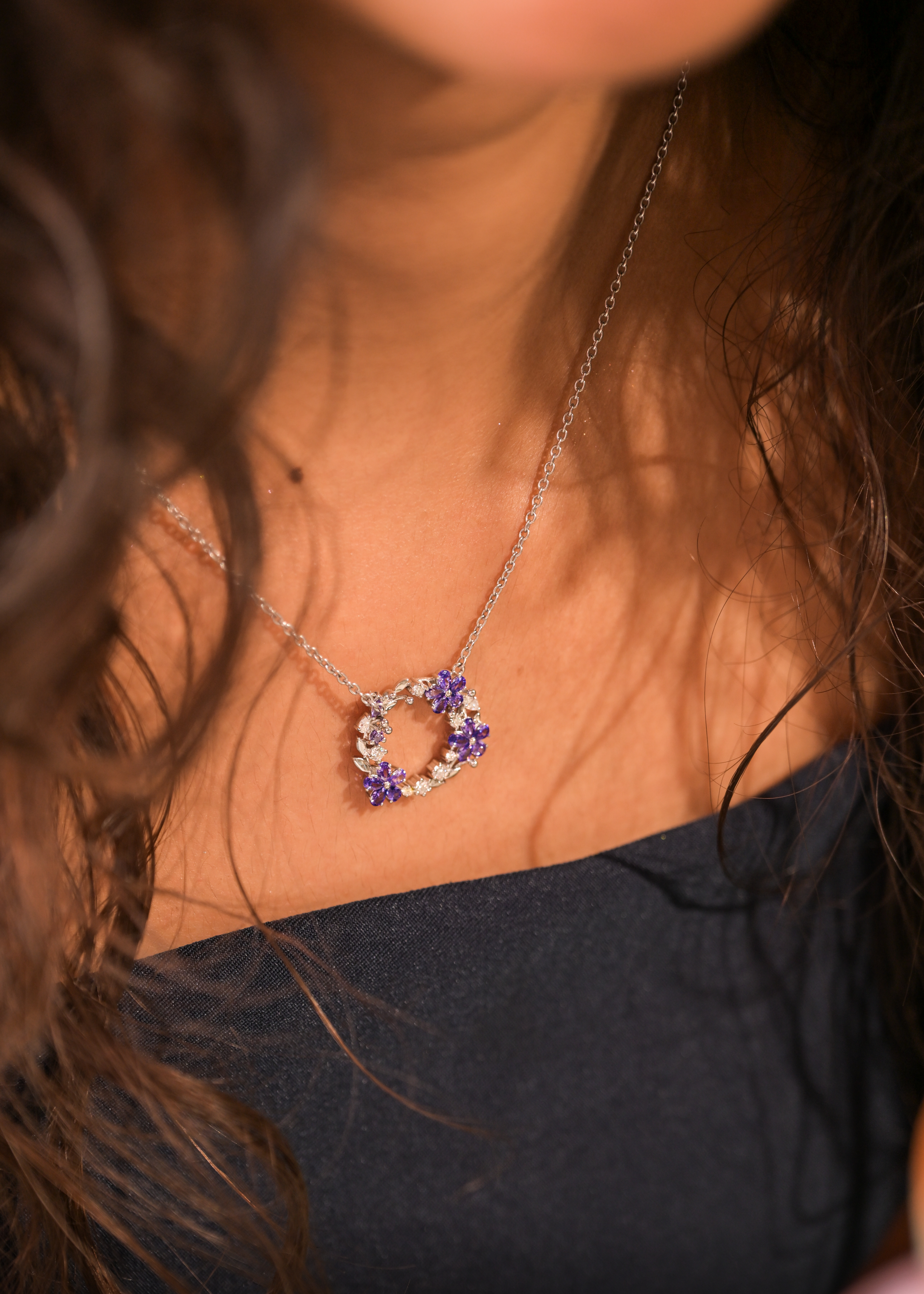 Heritage Necklaces - Purple floral pendant styled in warm natural light